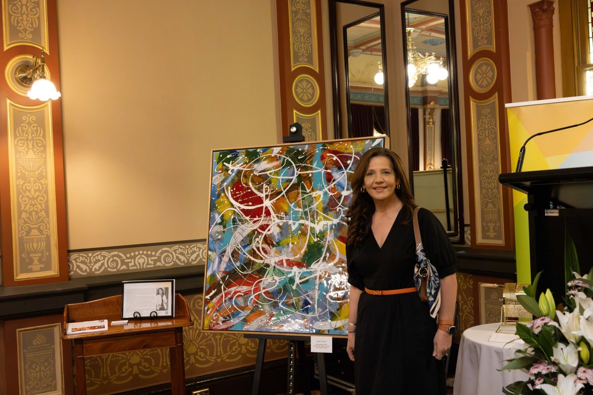 Artist Mary Di Carlo with her painting at High Tea at The Hotel Windsor